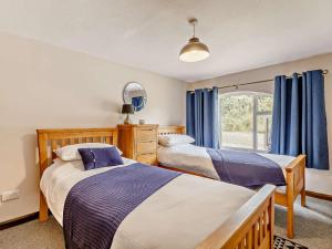 a bedroom with two beds and a window at 2 Bed in South Molton 88994 in Bishops Nympton