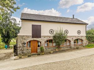 a stone house with brown doors and windows at 2 Bed in South Molton 88994 in Bishops Nympton