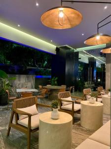 a restaurant with tables and chairs and lights at Grand Fiesta Americana Guadalajara Country Club in Guadalajara