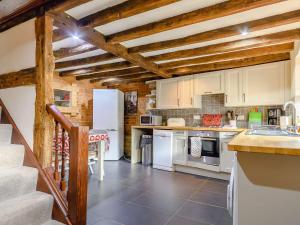 a kitchen with white appliances and wooden ceilings at 2 Bed in Bretforton 89476 in Bretforton