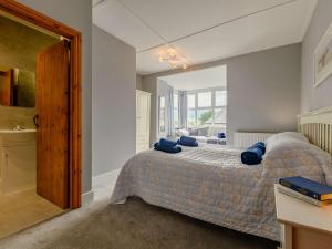 a bedroom with a bed with blue pillows on it at 2 bed property in Rothbury Northumberland 89502 in Thropton