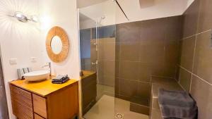 a bathroom with a shower and a sink at VILLA MAGIC - Ocean Views with Pool, Starlink WiFi, Cistern & Generator in Oyster Pond +10 photos
