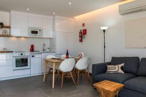 a kitchen and a living room with a couch and a table at Amor a Mar Starfish in Puerto del Carmen