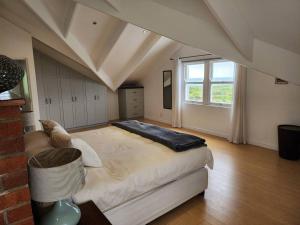 a bedroom with a large bed and a window at Penguin's at Sea in Grotto Bay +52 photos