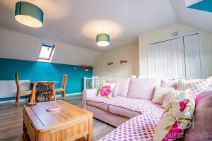 a living room with a couch and a table at Guest Homes - Chichester Close Flat in Hereford