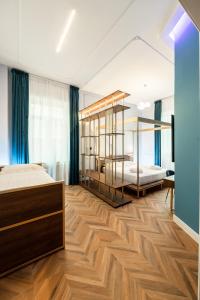 a bedroom with two beds and a wooden floor at Momento Soggiorno di Charme in Foggia