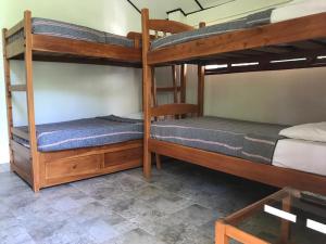 two bunk beds in a room with a table at Cabañas Don Rafa Santa Marta in Santa Marta