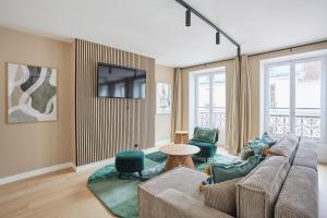 a living room with a couch and a tv at Residence beaubourg by Studio prestige in Paris