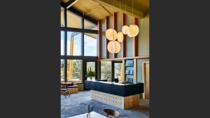 a lobby with a reception desk and large windows at Trailborn Rocky Mountains in Estes Park