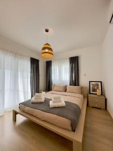 a bedroom with a large bed with two towels on it at Panorama Residence in Nicosia