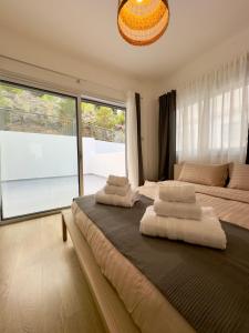 a bedroom with two beds and a large window at Panorama Residence in Nicosia