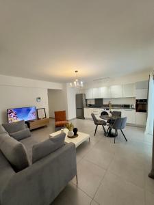 a large living room with a couch and a table at Panorama Residence in Nicosia