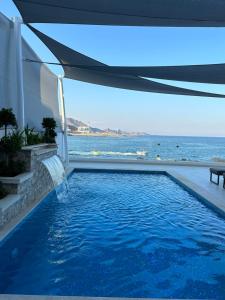 a swimming pool with a view of the ocean at Al Dana Sea View Villa in Fujairah