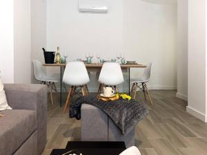 sala de estar con sofá y mesa con sillas en Apartamentos Gredos 001, en Jaraíz de la Vera