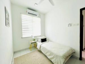 a white bedroom with a bed and a window at Cozy Scandi home @ Balok! in Kampung Saberang Balok