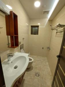 a bathroom with a sink and a toilet at شقق كيان البستان للشقق المخدومة in Al Ahsa