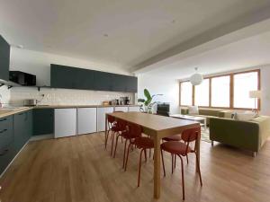 cocina y sala de estar con mesa y sillas en La Casa Calot, en Angers