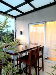 a dining room table with chairs and a large window at Spacious, Scenic & Homely Loft in Kigali