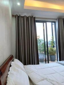 a bedroom with a bed in front of a window at Spacious, Scenic & Homely Loft in Kigali