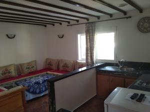 a room with a bed and a kitchen with a sink at Casa Abdou in Chefchaouen