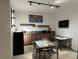 a kitchen and dining room with two tables and a counter at La Sella dei Nebrodi in Mistretta