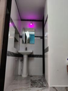 a bathroom with a sink and a mirror at Supritha Homestay Hampi in Hampi