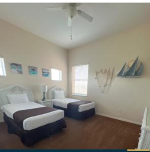 a bedroom with two beds and a ceiling at Bahama Bay 116 in Kissimmee