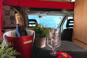 a table with a bottle of wine and a glass at Akisol Azeitão Ride in Azeitao