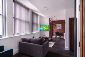 a living room with a couch and a tv at 1 Bed Apartment in Central Liverpool w Balcony in Liverpool