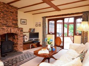 a living room with a couch and a fireplace at 3 Bed in Dulverton RDOOR in Exton