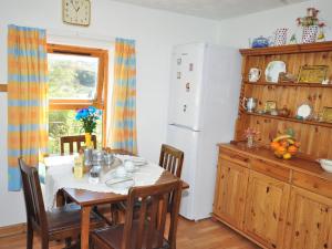 a kitchen with a table and a white refrigerator at 1 bed property in Lochinver The Highlands SU304 in Lochinver