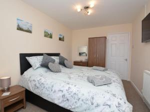 a bedroom with a bed with a white comforter at 3 bed property in Mablethorpe 43220 in Mablethorpe