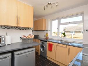 a kitchen with a sink and a dishwasher at 3 bed property in Mablethorpe 43220 in Mablethorpe