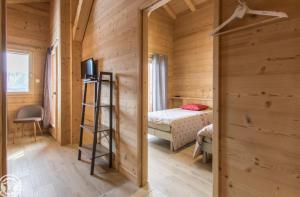 a small room with a bed and a television at Chalet Le Gypaète in Le Grand-Bornand