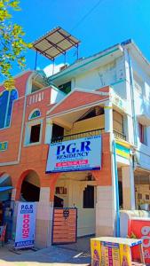 a building with a sign in front of it at PGR Thirunallar in kāraikāl
