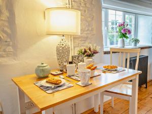 a dining room table with food and a lamp at 1 Bed in Kidwelly 43406 in Kidwelly