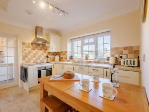 a kitchen with a wooden table in a kitchen at 2 Bed in Llangollen 43916 in Overton