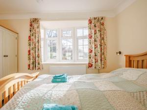 a bedroom with a bed and a window with curtains at 2 Bed in Llangollen 43916 in Overton