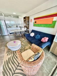 sala de estar con sofá azul y mesa en Cimarron Suites Playa Parguito, en El Cardón