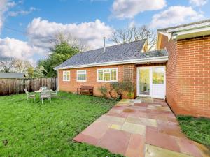 a brick house with a yard with a patio at 2 Bed in Llangollen 43916 in Overton
