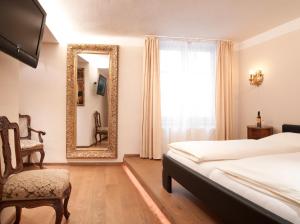 Televízia a/alebo spoločenská miestnosť v ubytovaní Altstadthotel Kasererbräu