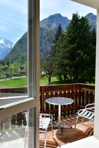 a view from a window of a patio with a table and chairs at Hotel Saisera in Valbruna