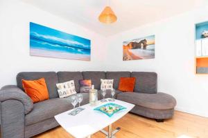 a living room with a couch and a table at BOURNECOAST- NEAR TOWN CENTRE and BEACH with BEACH HUT - FM6114 in Bournemouth