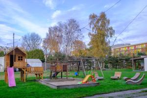 a park with a playground with a swing at Domki Ajna Park w uzdrowisku in Kołobrzeg