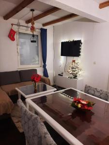 a living room with a table and a christmas tree at Villa Apartments B&D in Ohrid