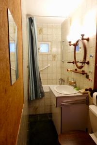 a bathroom with a sink and a mirror and a tub at CHARMANTE MAISON A SAINT GUILHEM LE DESERT in Saint-Guilhem-le-Désert