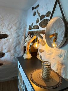 uma mesa com duas luzes e um espelho na parede em Charmant duplex 2 chambres/terrasse em Prades