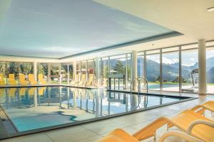 Casa con piscina con sillas y montañas en Villa Scherlin, en Ortisei