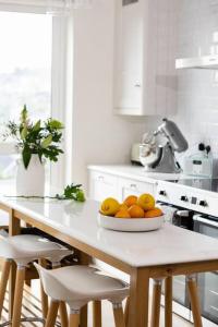 a kitchen with a table with a bowl of oranges on it at Luxury Waterfront House in Cobh