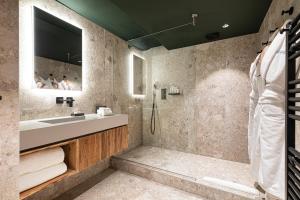 a bathroom with a sink and a shower at Hotel Le Chabichou in Courchevel